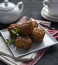 Some carrot muffins with nuts and mint white cup of tea breakfast bakery