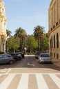 some cars are parked near the stop sign on a city street Royalty Free Stock Photo