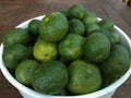 some citrus oranges on a bucket