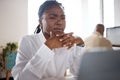 Some clarity would be appreciated. a young businesswoman using a laptop in a modern office.