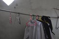 some clothes are dried and hung indoors, laundry, clothesline