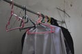 some clothes are dried and hung indoors, laundry, clothesline