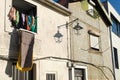 Some clothes lying on a balcony on a tiled facade wall in a urban scene in Porto
