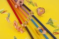 Some colored pencils of different colors and a pencil sharpener and pencil shavings on ÃÂ° yellow background Royalty Free Stock Photo