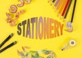 Some colored pencils of different colors and a pencil sharpener and pencil shavings on the yellow background. Word Stationery