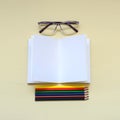 Some colored pencils with glases and opened notebook Royalty Free Stock Photo