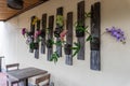 Some colorful orchid flowers and types of wall decorations in a restaurant in Ubud, Bali