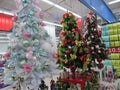 Some colorful Christmas trees with decorations at a departmental store