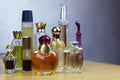 Some rows of perfume bottles on wooden table. Old vintage perfumes. Royalty Free Stock Photo