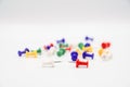 Some colorful pushpins on white paper Royalty Free Stock Photo