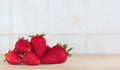 Some colorful strawberries inside a kitchen