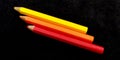 Some colorful wooden pencil isolated on black background