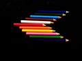 Some colorful wooden pencil isolated on black background