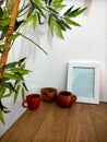 Some cups and photo frame under bamboo tree Royalty Free Stock Photo