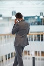 Some decisions with be your biggest letdown. Rearview shot of a young businessman looking stressed out while standing in Royalty Free Stock Photo