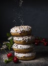 Some delicious donuts at each other with cherry berry on dark background colorful sprinkles front Royalty Free Stock Photo