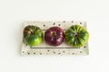Some delicious ripe tomatoes of two varieties on a porcelain tray