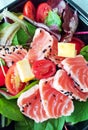 Delicious slices of scalded salmon with salad