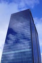 Reflection of clouds in a modern glass office building in the city Royalty Free Stock Photo