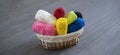 the some different colorful yarn rolls in the basket on shelf or table at home, homemady hobby wide webn banner