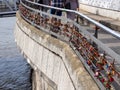 Some different padlocks hang on a bridge