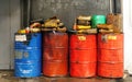 Dirty & oily plastic canisters on waste oil barrels tank