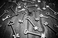 Some door keys on old wooden surface, safety, security concept background. Black and white photo Royalty Free Stock Photo