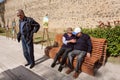 Some elderly men talking with emotions on street bench of old town of Georgia Royalty Free Stock Photo