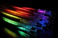 Some fibre optic cables glowing at the end in different colors against a black background created with generative AI technology