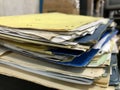 Some file folders stacked on top of a desk