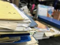 Some file folders stacked on top of a desk