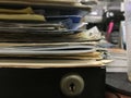 Some file folders stacked on top of a desk