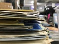 Some file folders stacked on top of a desk