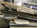 Some file folders stacked on top of a desk