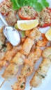 Some fish skewers with shrimp and swordfish baked in the oven Royalty Free Stock Photo