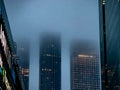 Three huge skyscrapers are hidden in thick fog