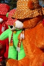 Some fluffy dolls are being sold outside an indian heritage tourist place. These colorful pandas look innocent and charming