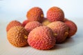 Some fresh lychees on a white cutting board Royalty Free Stock Photo