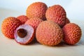 Some fresh lychees on a white cutting board