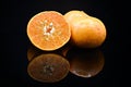 Some fresh oranges on black background