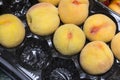 Some fresh yellow peaches in a black box, fruit Royalty Free Stock Photo
