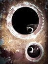 Some gear holes that look pretty chilly metalic texture abstract photograph with peeping through the other side like a key hole