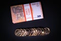 Some gold coins lie next to a stack of euro banknotes Royalty Free Stock Photo