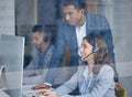 This is some good work. a handsome young male call center floor manager supervising his staff in the office. Royalty Free Stock Photo