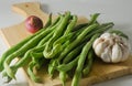 Some green beans, a red onion and a garlic bulb Royalty Free Stock Photo