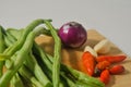Some green beans, some red chili peppers, two cloves of garlic and a red onion Royalty Free Stock Photo