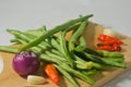 Some green beans, some red chili peppers, two cloves of garlic and a red onion Royalty Free Stock Photo