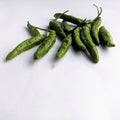 some green chilies on a white background