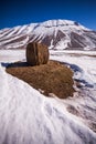 Some hay bales in the snow in Pian grande and Mount Vettore in the background, Castelluccio di Norcia, Umbria, Italy Royalty Free Stock Photo