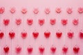 Some heart shape red lollipop candy on pastel pink background. Minimal Valentine or love concept. Royalty Free Stock Photo